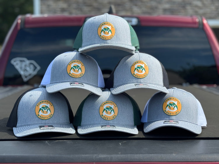Stack of light blue hats with full-color company logo patches