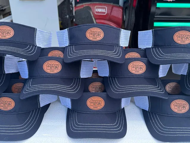Navy and white trucker hats with custom patches